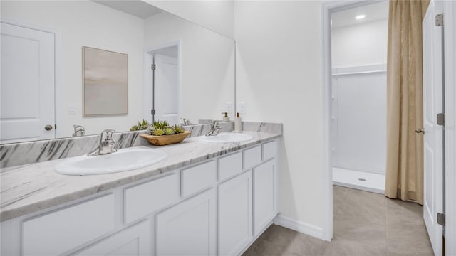 bathroom with tile patterned flooring, a shower, and vanity