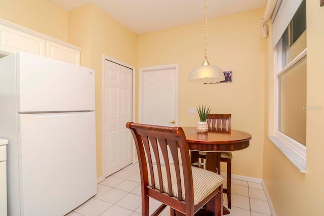 dining area featuring light tile patterned flooring