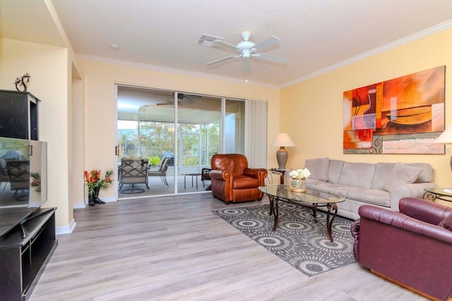 living room featuring a textured ceiling, hardwood / wood-style flooring, ceiling fan, and crown molding