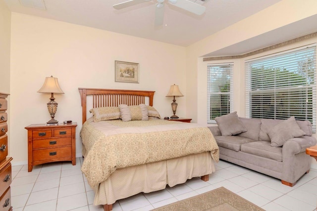 tiled bedroom featuring ceiling fan