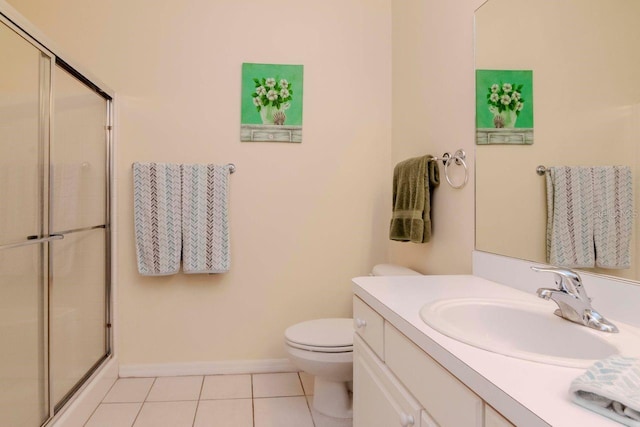 bathroom featuring tile patterned floors, toilet, vanity, and walk in shower