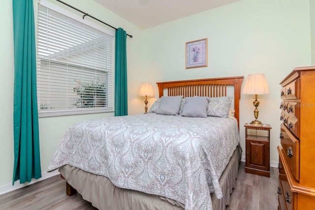 bedroom with light hardwood / wood-style floors