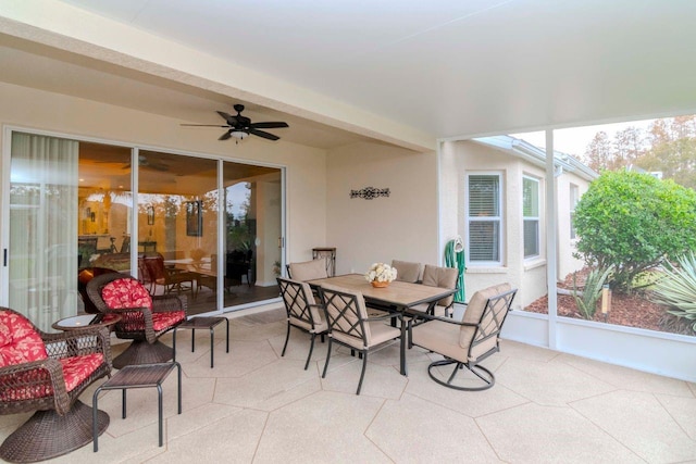 sunroom / solarium featuring ceiling fan