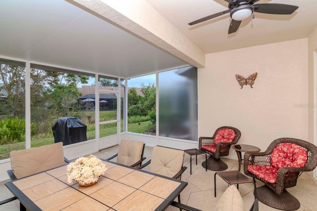 sunroom / solarium featuring ceiling fan