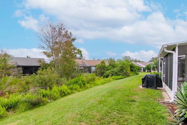 view of yard featuring a sunroom