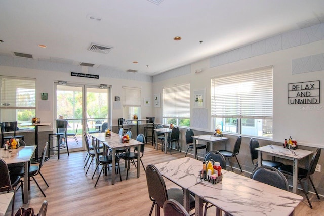 dining room with a healthy amount of sunlight and light wood-type flooring