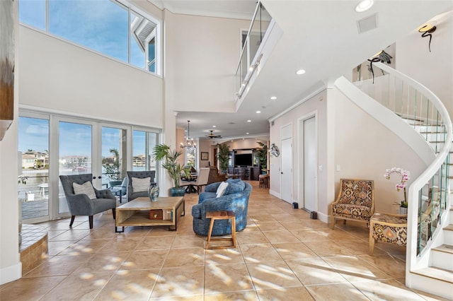 tiled entrance foyer featuring ornamental molding and a towering ceiling