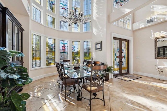 sunroom / solarium with french doors and a chandelier