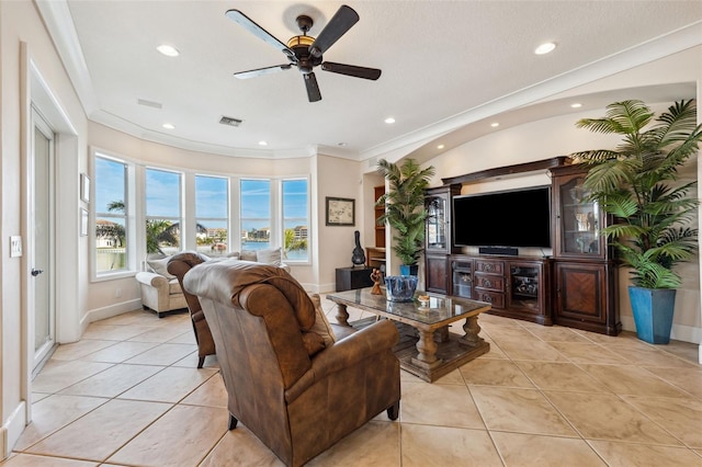 tiled living room with crown molding and ceiling fan