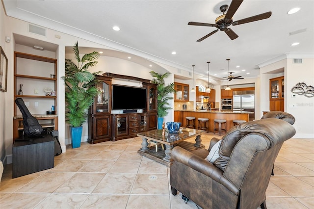 tiled living room featuring crown molding and ceiling fan