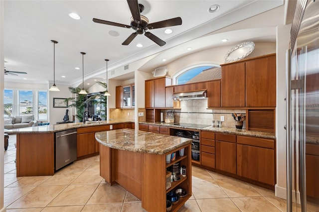 kitchen featuring decorative light fixtures, a center island, stainless steel appliances, and kitchen peninsula