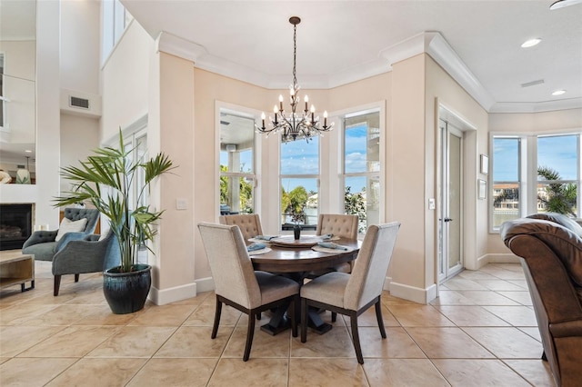 dining space featuring ornamental molding, an inviting chandelier, and light tile patterned floors