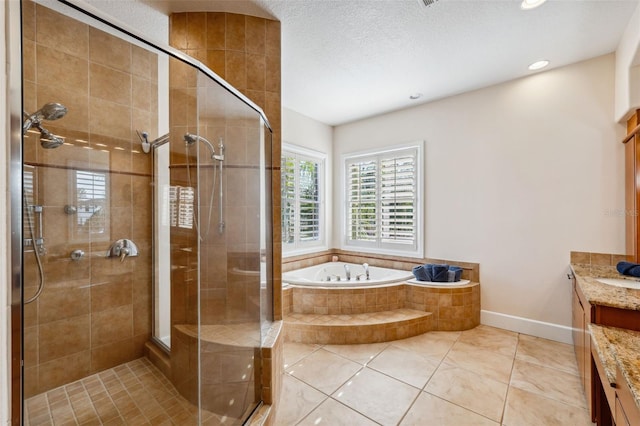 bathroom with a textured ceiling, vanity, tile patterned flooring, and shower with separate bathtub