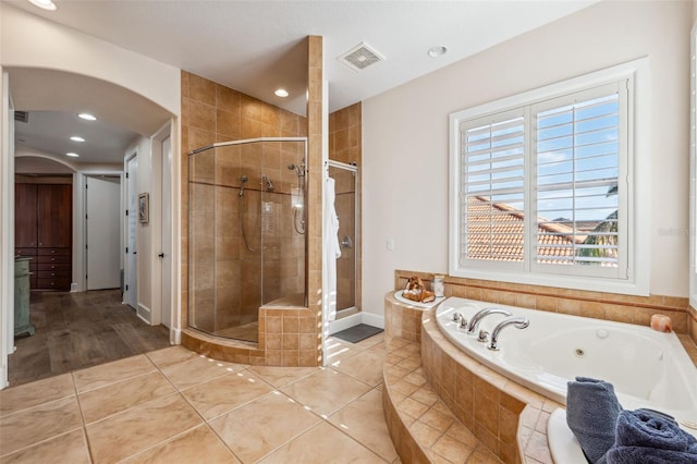 bathroom featuring plus walk in shower and tile patterned floors