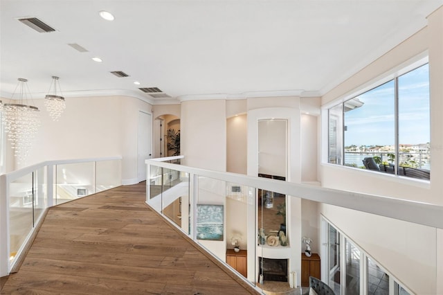 corridor featuring hardwood / wood-style flooring and ornamental molding