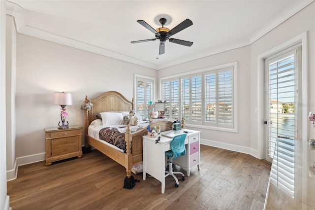 bedroom with multiple windows, dark wood-type flooring, and ornamental molding