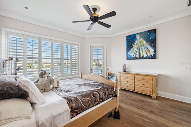 bedroom with ceiling fan, crown molding, and dark hardwood / wood-style flooring