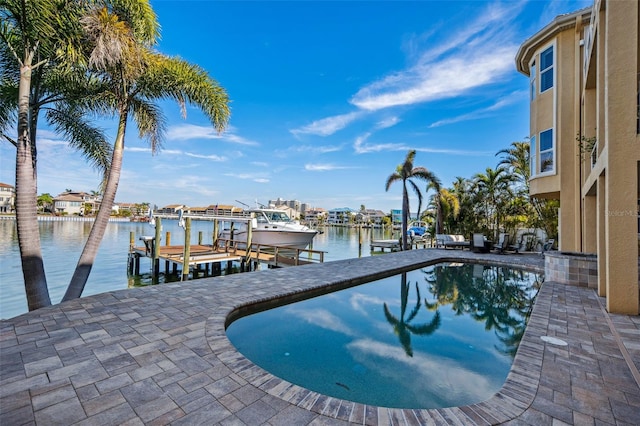 view of pool with a water view and a boat dock