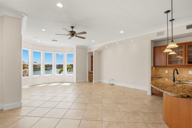 6015 Kipps Colony Dr E, Gulfport, FL 33707 - unfurnished living room with recessed lighting, ceiling fan, light tile patterned floors, a water view, and ornamental molding