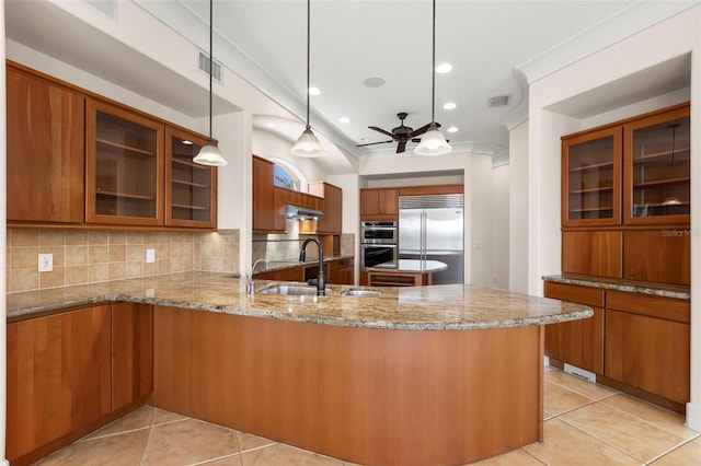 6015 Kipps Colony Dr E, Gulfport, FL 33707 - kitchen featuring appliances with stainless steel finishes, brown cabinetry, a ceiling fan, a peninsula, and recessed lighting