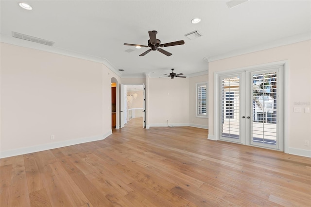 6015 Kipps Colony Dr E, Gulfport, FL 33707 - unfurnished living room featuring a ceiling fan, ornamental molding, recessed lighting, light wood-style floors, and arched walkways