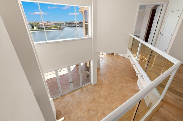 6015 Kipps Colony Dr E, Gulfport, FL 33707 - stairs with a water view and baseboards