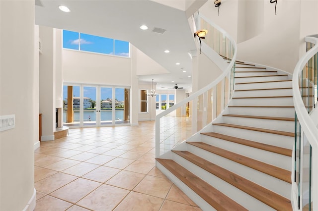 6015 Kipps Colony Dr E, Gulfport, FL 33707 - stairs with a high ceiling, tile patterned floors, a water view, and recessed lighting