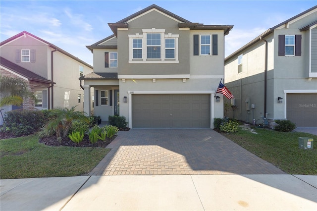 view of front of property with a front lawn and a garage