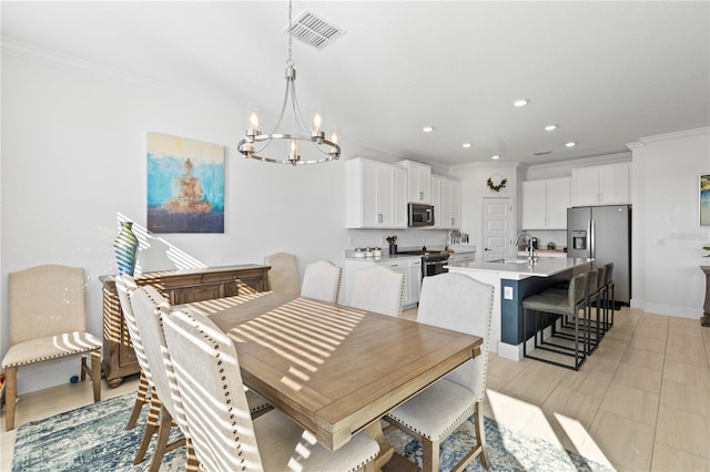 tiled dining space with a notable chandelier, crown molding, and sink