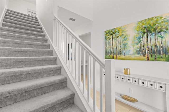 stairway with tile patterned floors