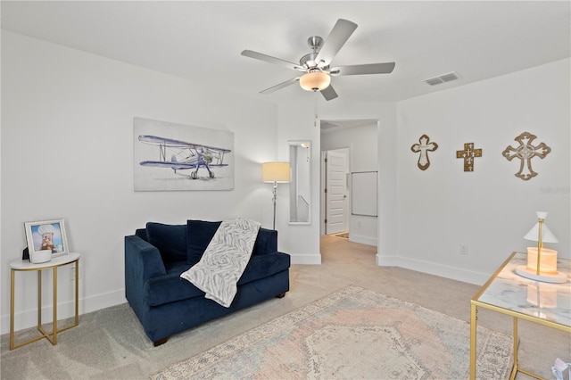 living area featuring carpet and ceiling fan