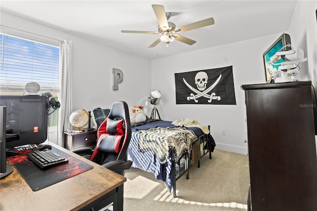 bedroom featuring light colored carpet and ceiling fan