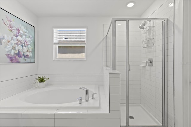 bathroom featuring separate shower and tub