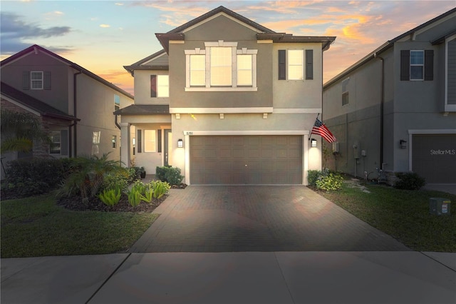 view of property featuring a yard and a garage