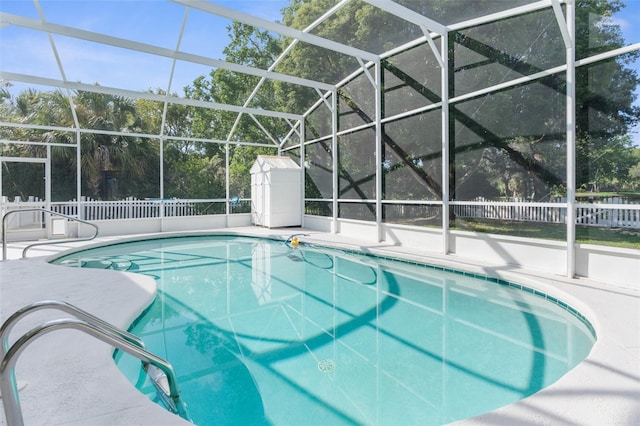 view of swimming pool with a lanai and a patio