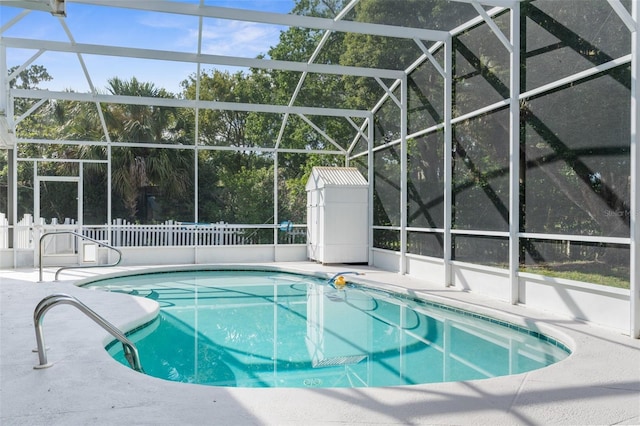 view of swimming pool with glass enclosure and a patio