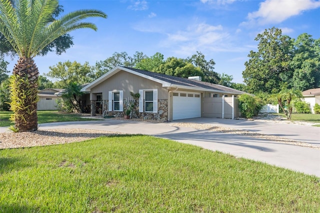 ranch-style home with a garage and a front lawn