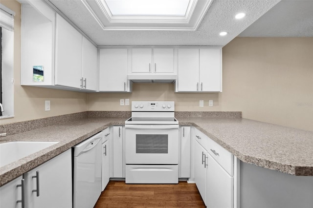 kitchen featuring sink, white appliances, white cabinetry, dark hardwood / wood-style floors, and a textured ceiling