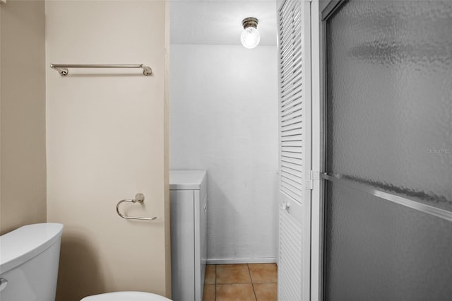 bathroom featuring tile patterned floors and toilet