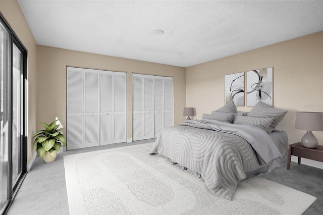 carpeted bedroom featuring multiple closets and a textured ceiling