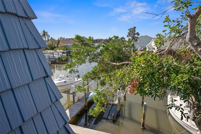 balcony with a water view and a boat dock