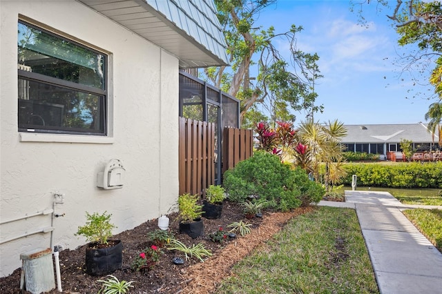 view of side of property with glass enclosure