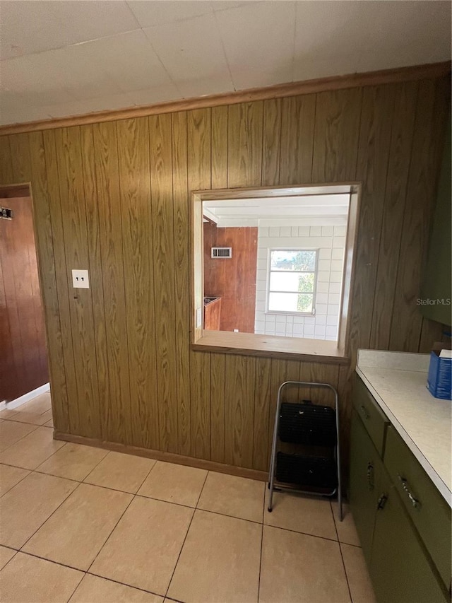 bathroom featuring tile patterned flooring and wooden walls