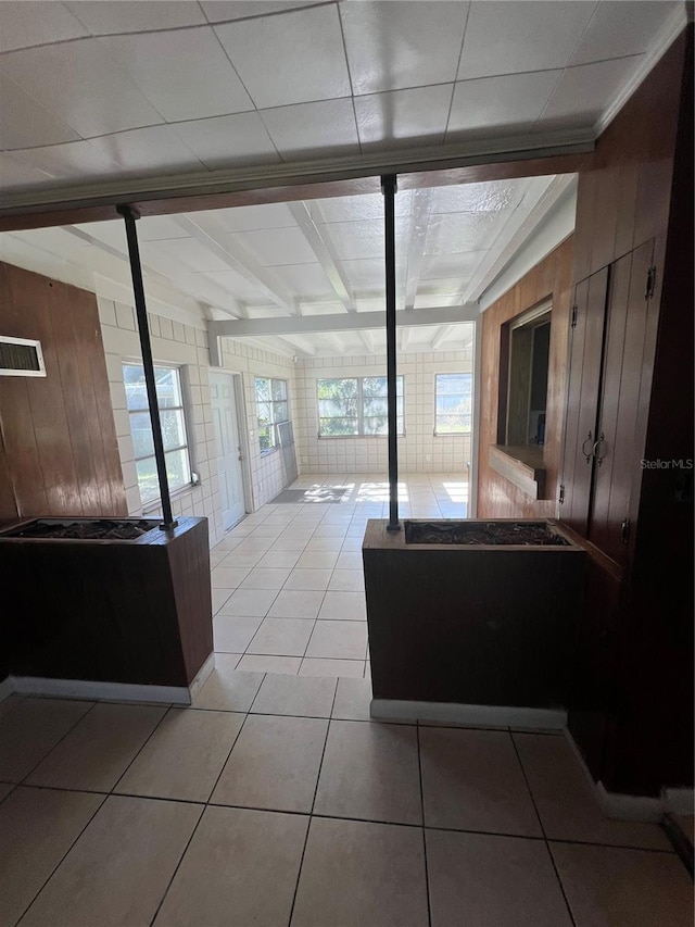 bathroom featuring beamed ceiling and tile patterned floors