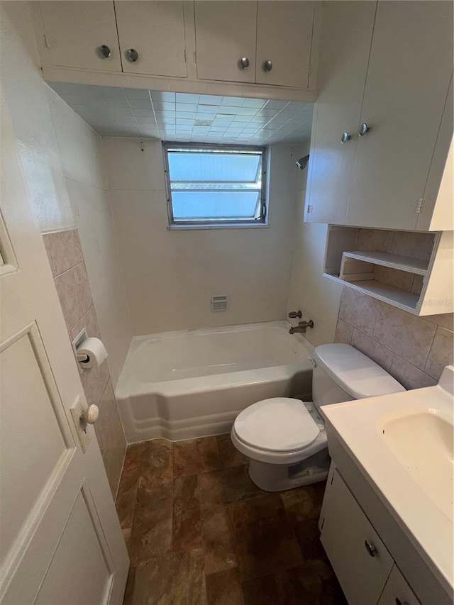 full bathroom featuring vanity, bathing tub / shower combination, decorative backsplash, toilet, and tile walls