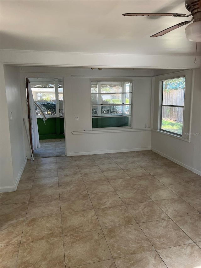 tiled empty room with ceiling fan