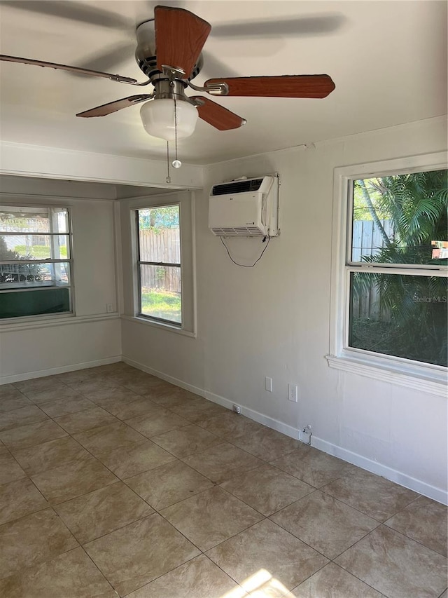 tiled empty room with a wall mounted air conditioner and ceiling fan