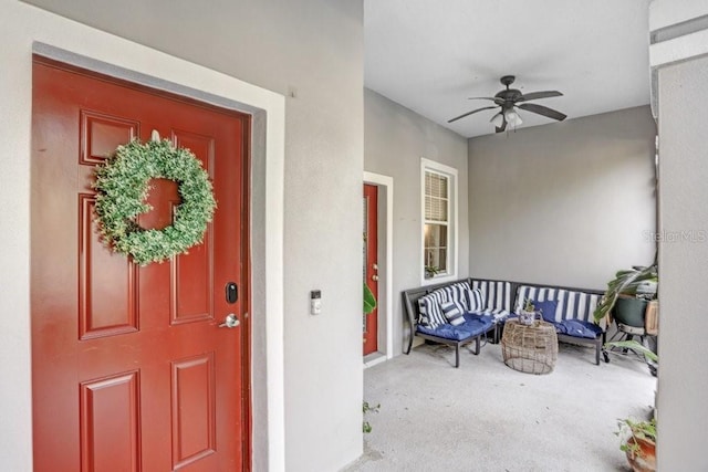 property entrance featuring ceiling fan and covered porch