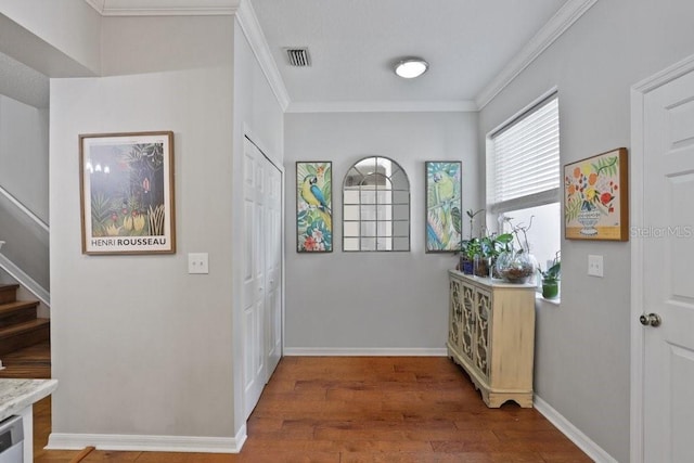 corridor featuring hardwood / wood-style flooring and ornamental molding