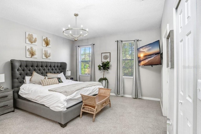 bedroom featuring light carpet, baseboards, a chandelier, and a textured ceiling